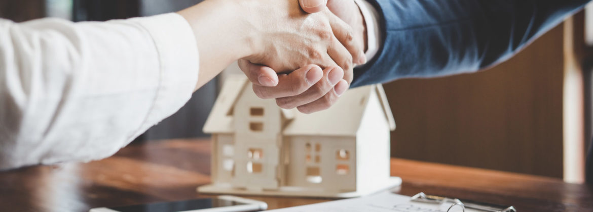 shaking hands with home in background