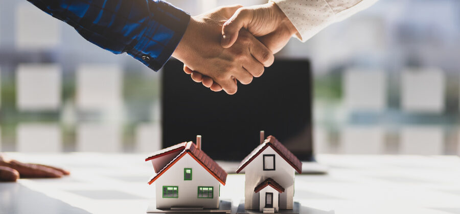 Real estate agents shake hands after the signing of the real estate agreement is complete